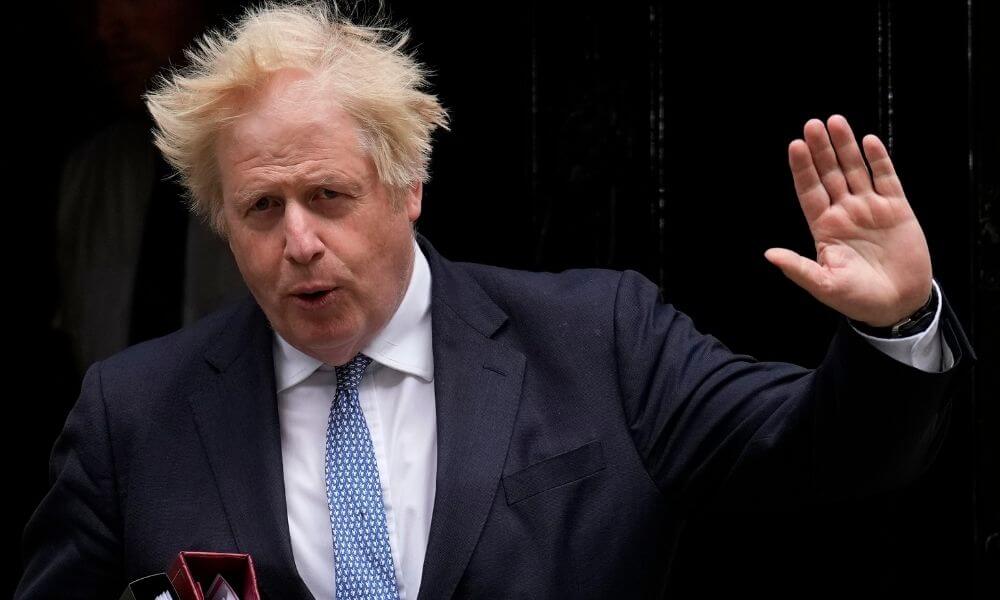 Boris Johnson defies calls to resign amid mass exodus from his government